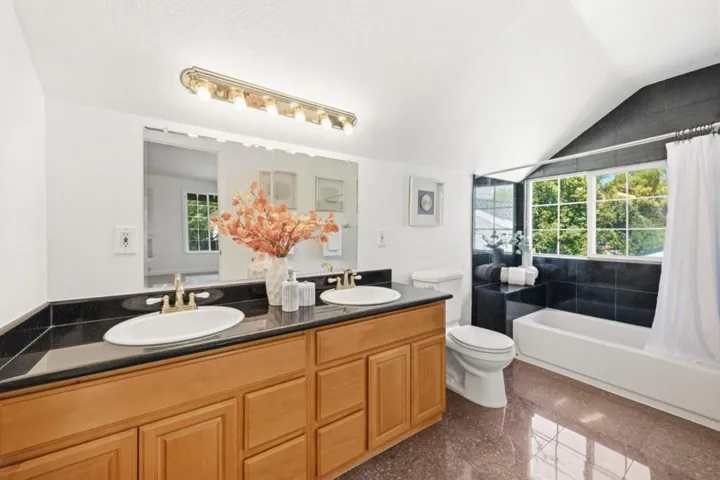 2nd story primary bath with couble sinks, shower over tub.