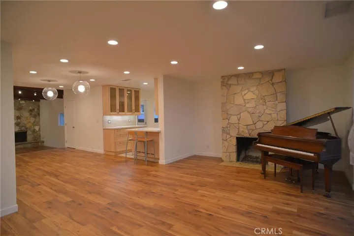 Living room/fireplace/kitchen entry (piano removed/not included)