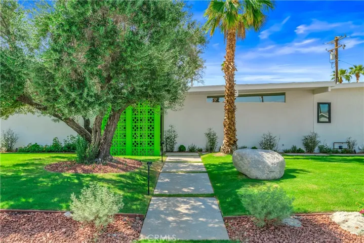 "Lush landscaping and architectural breeze block details create a memorable arrival experience."