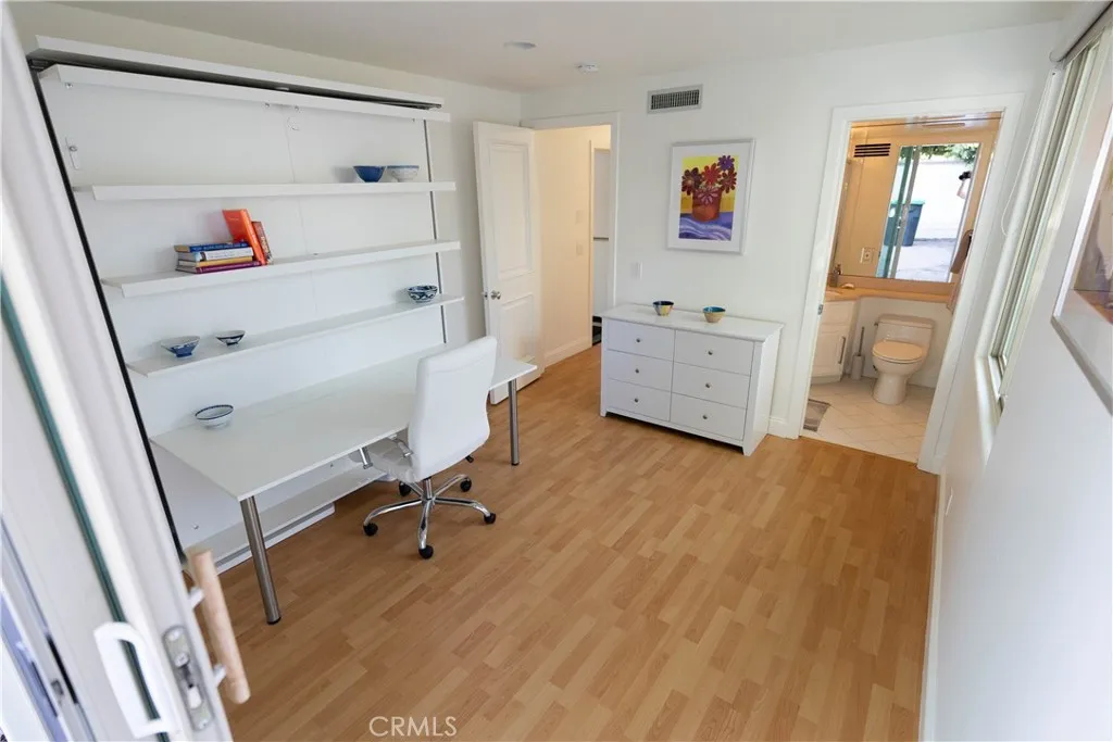 2nd level office/bedroom., ensuite.  Shelves are a Murphy bed.
