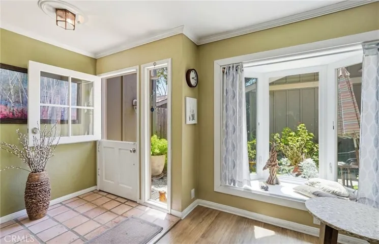 The entry way is beautiful, complimented by dutch door and bay window.