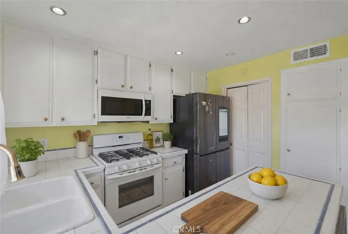The kitchen is very large with plenty of counter space, pots and pan drawers, recessed lighting and opens to the large, private patio with beautiful ocean breezes !