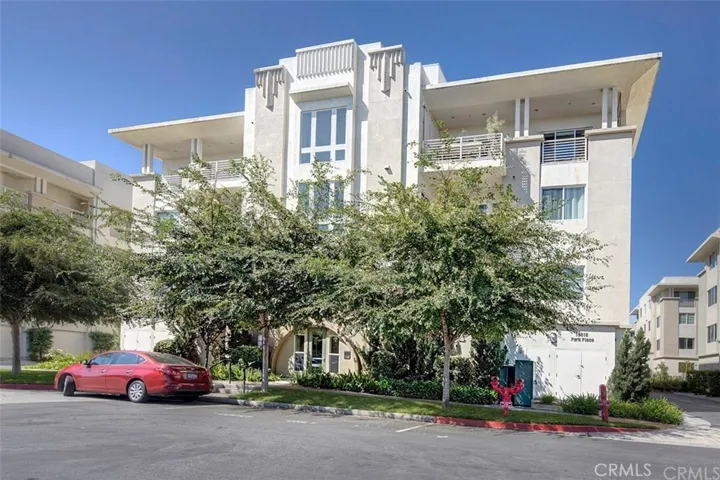 Front of the Building.  Unit is on the 2nd Floor on the Right in the Front with large sun windows and views of the Pool and Club House.