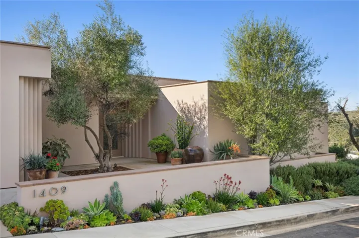 Low-maintenance, water-wise landscaping surrounds the residence, complementing the limestone decks and outdoor living areas.