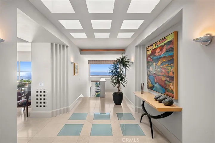 Encompassing approximately 5,603 square feet, the four-bedroom, four-and-one-half-bath home is thoughtfully designed to maximize light and scale, with dramatic coastal panoramas complemented by Catalina Island and city-light views throughout the living spaces.
