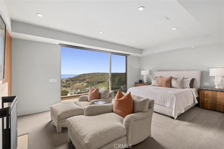 The primary suite on the main level offers ocean-view deck access, a fireplace, walk-in closets,.