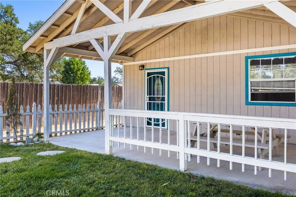 Guest house offers a covered patio, fenced front lawn and views of the pastoral landscape