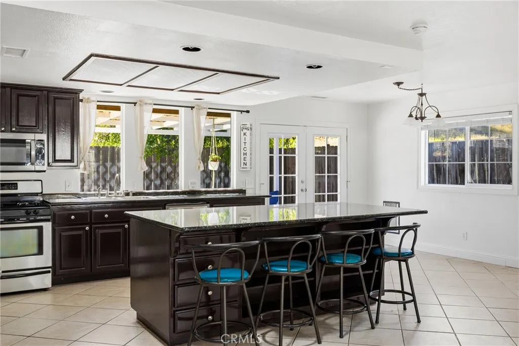 Kitchen & Dining Area offers recessed lighting, large island for entertaining, French doors provide direct access to the backyard patio.