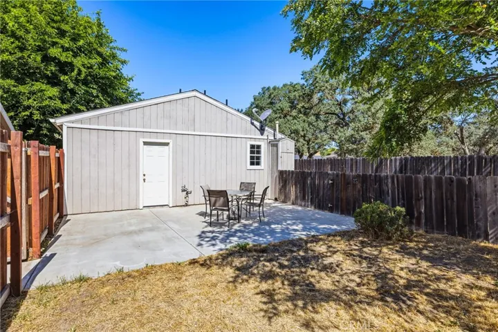 Guest House Backyard – Private fenced backyard with a spacious patio and direct access to the guest bedroom, offering a comfortable outdoor retreat.