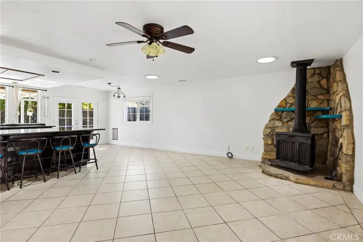 Skylights in the living room add natural lighting, free standing wood burning stove with rock wall accent provide warmth during those chilly winter nights