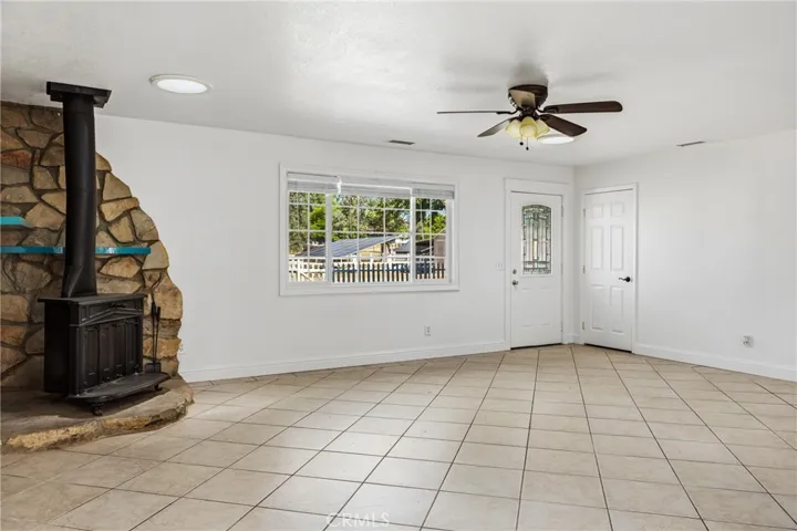 Enjoy outdoor views from the living room with easy maintenance tile flooring, skylights add natural lighting to the room