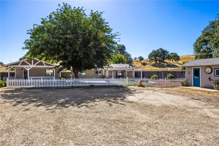 Main Residence and quest house, each with separate landscaped white picket fenced yards