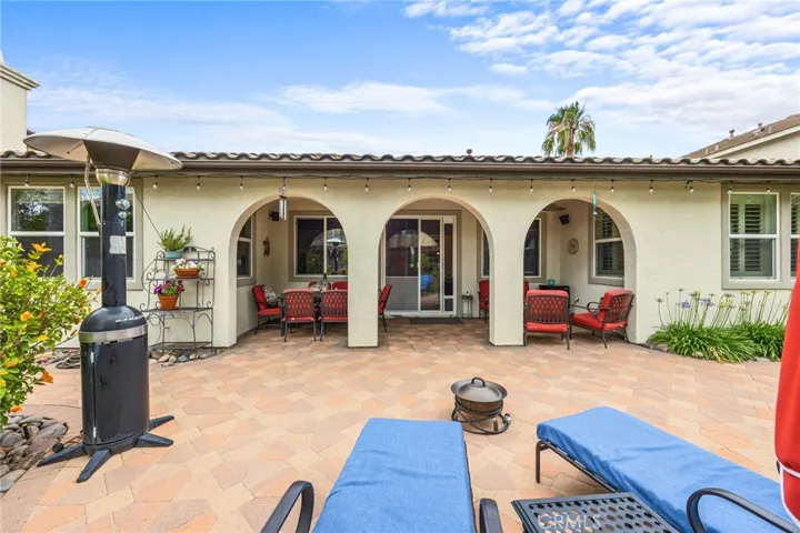 Covered Patio with Game Room access and custom Stone Pavers