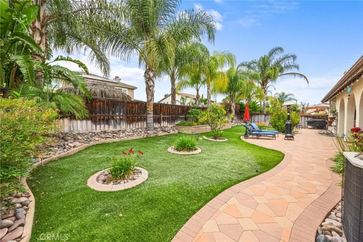 Low Maintenance Tropical Backyard with Artificial Turn, Drip Lines & custom Stone Paver Walkways