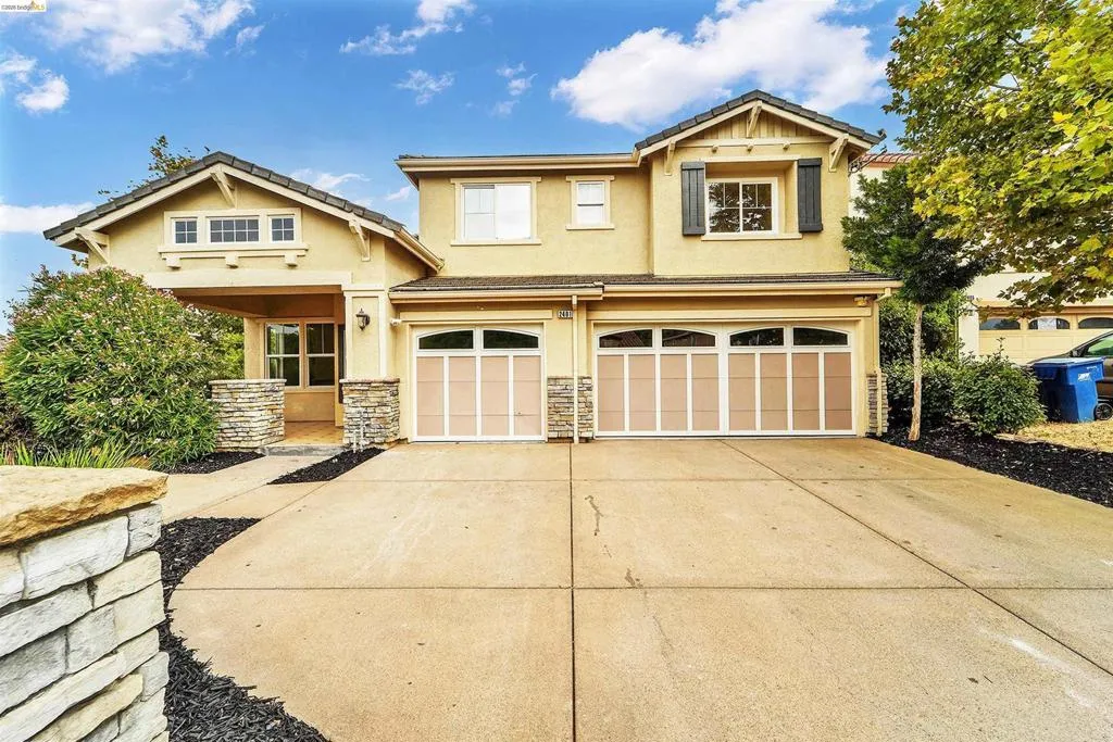Stucco exterior with stone accents and a two-car garage