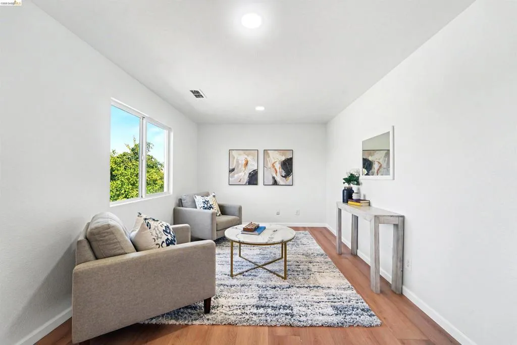 Bright interior space featuring wood-finish flooring, white walls, and recessed lighting