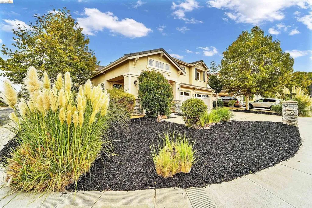 Stucco exterior with stone accents and an attached two-car garage
