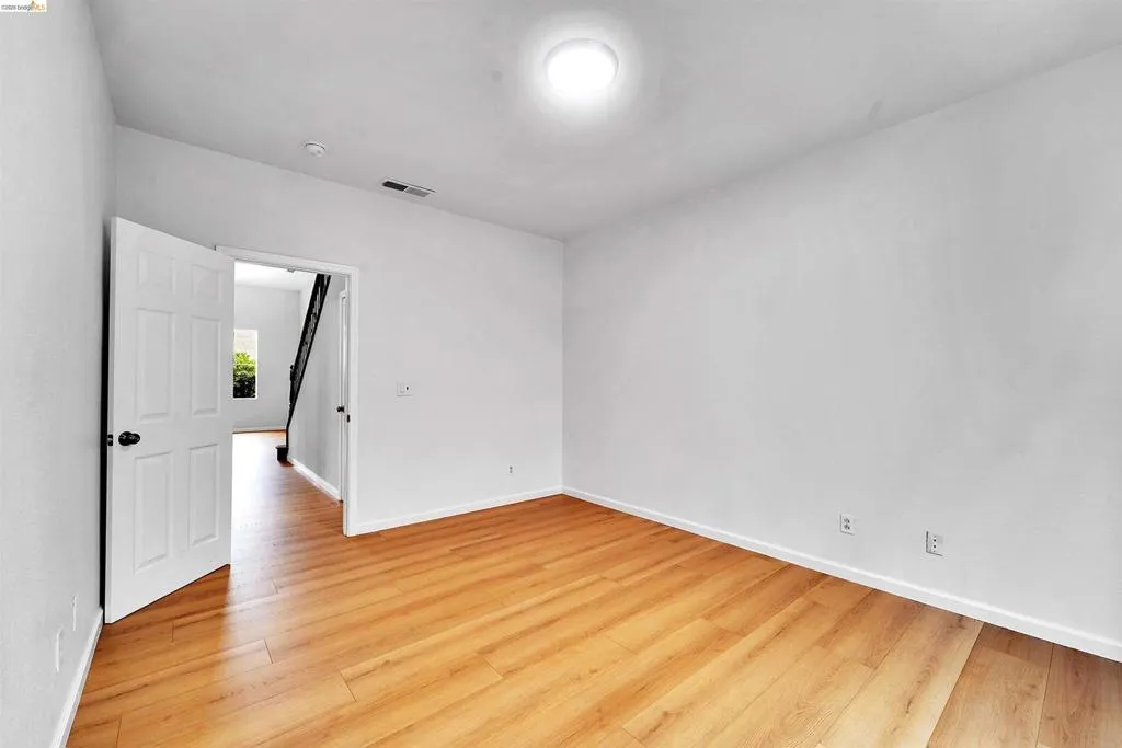 Bright room featuring wood-finish flooring and a flush-mount ceiling light