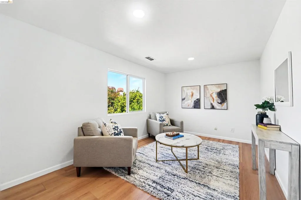 Bright interior space featuring wood-finish flooring, white walls, and recessed lighting
