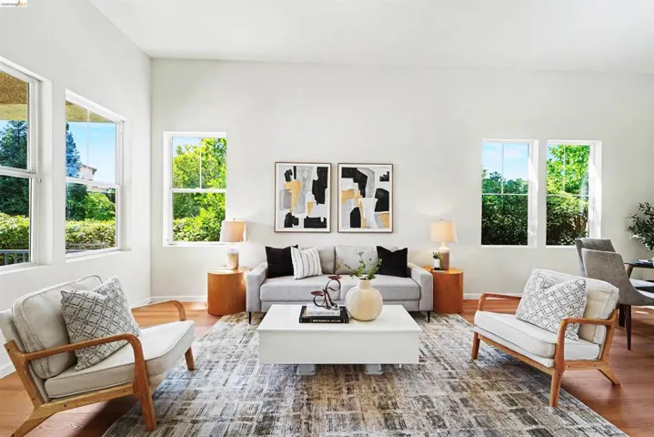 Spacious living area featuring high ceilings and wood-finish flooring