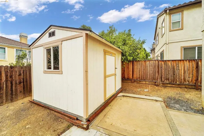 Detached storage shed featuring a single window and gabled roofline