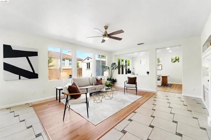 Bright living area featuring wood-finish flooring and a ceiling fan
