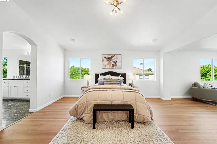 Bright interior space featuring light wood-finish flooring and multiple windows