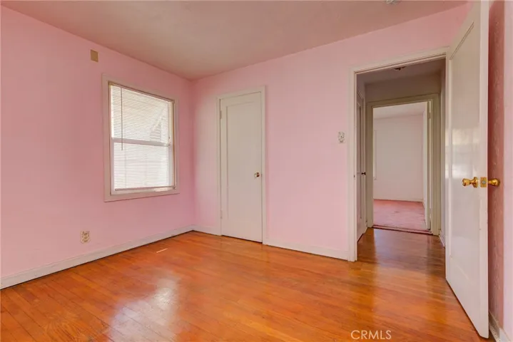 Pink bedroom, unveiled hardwood floor!
