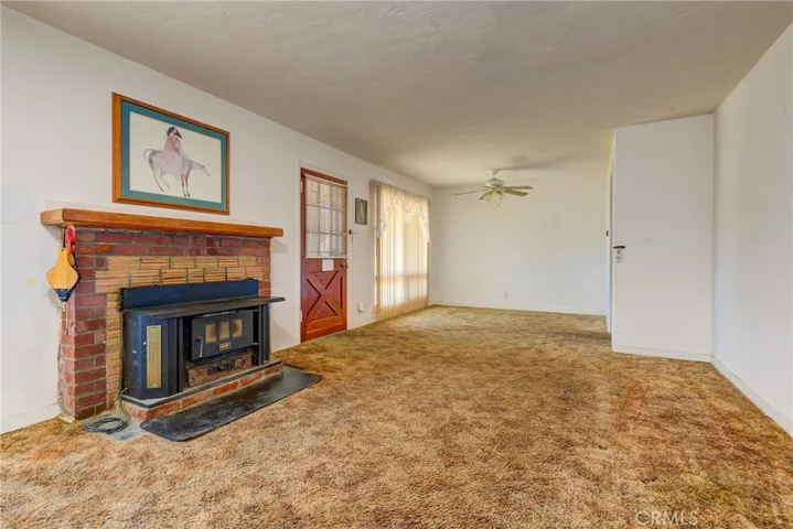 Living room, has fireplace/ wood stove insert
