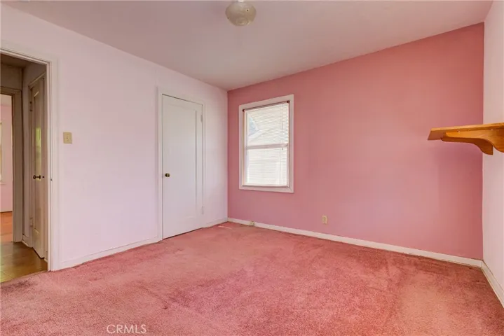 Nice size bedroom! Rose carpet room.