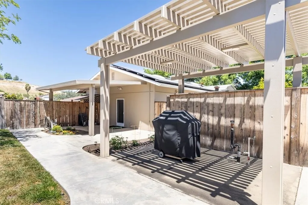 Concrete walk to BBQ and door to garage/shop