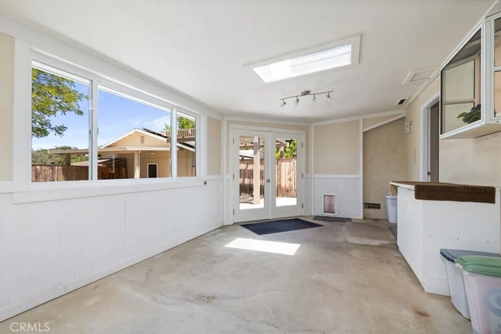 So much potential in this enclosed sunroom with french doors to back yard.