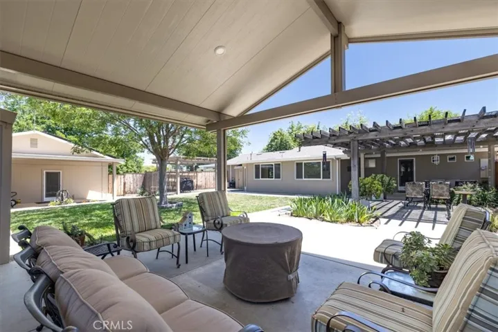 Large covered patios in fenced back yard.