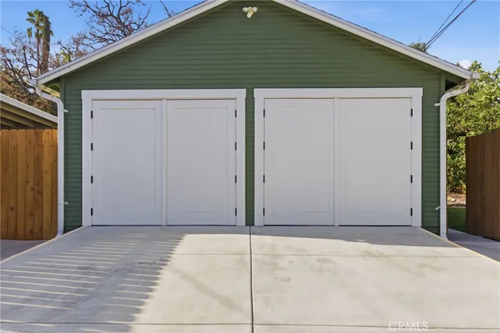 Front of garage on alley with 5 parking spaces
