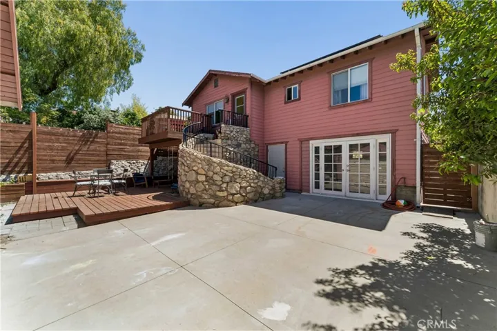 Looking at the beautiful stone surround staircase and double door entry to walk-out basement