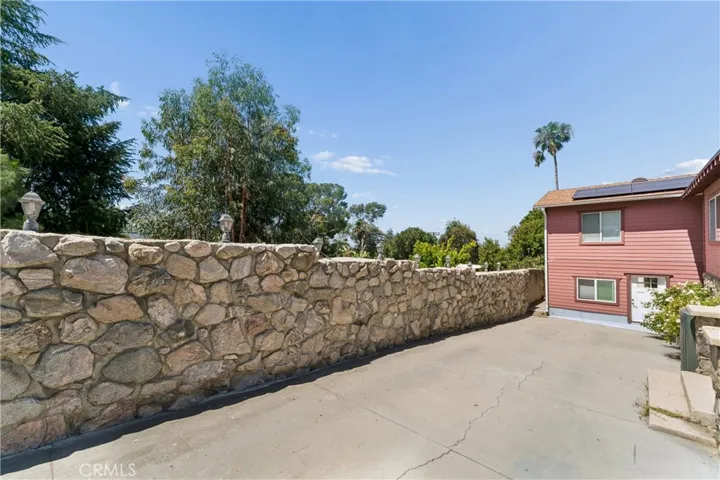 Long stone-lined driveway leading to home.