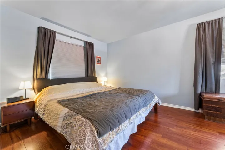 Large Primary Bedroom featuring beautiful wood flooring and expansive natural light.