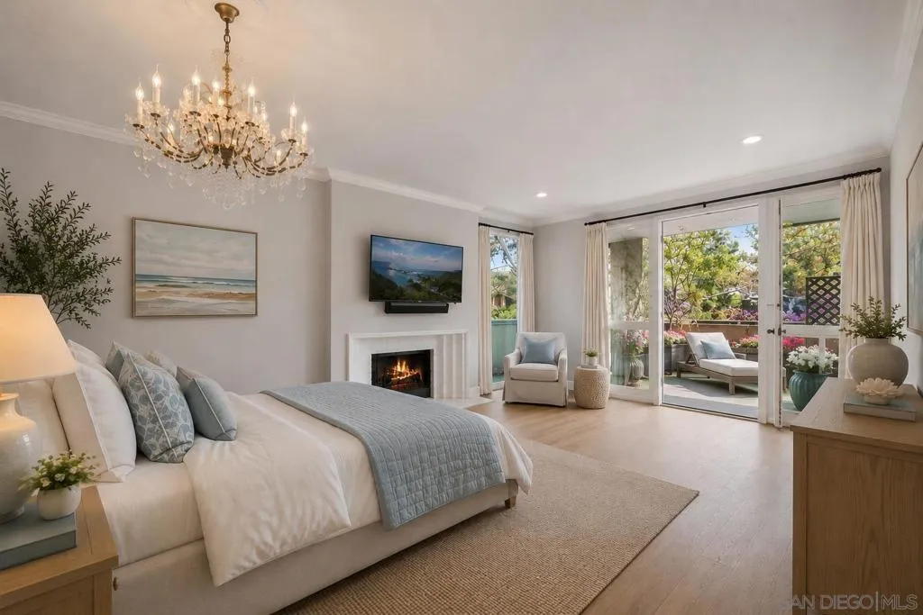 Huge Primary Bedroom with and Gas/Wood Burning Fireplace, Floor to Ceiling Windows and Doors Opening to the Large Outdoor Covered Terrace/Balcony offering Ocean Breezes and Views of Mount Soledad and Trees. Virtually Staged.
