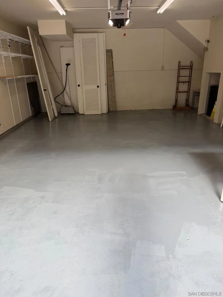 Large Two Car Garage with a Sink and Shelves.