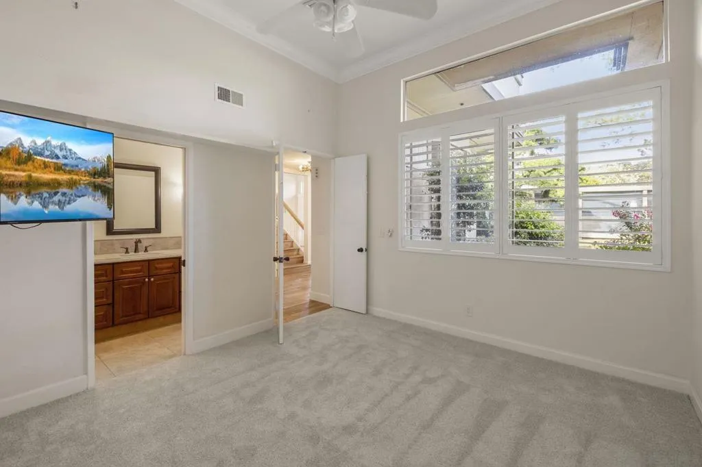 1st Floor Guest Bedroom with High Ceilings, Bathroom Ensuite and Custom Curated Plantation Shutters.