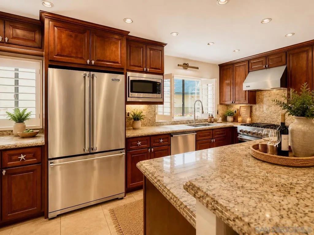 Open Floor Plan Kitchen with Kitchen Island Bar Area Dining, with Upgraded Viking Kitchen Appliances, Baseboards & Crown Moulding, and Custom Plantation Shutters. Virtually Staged.