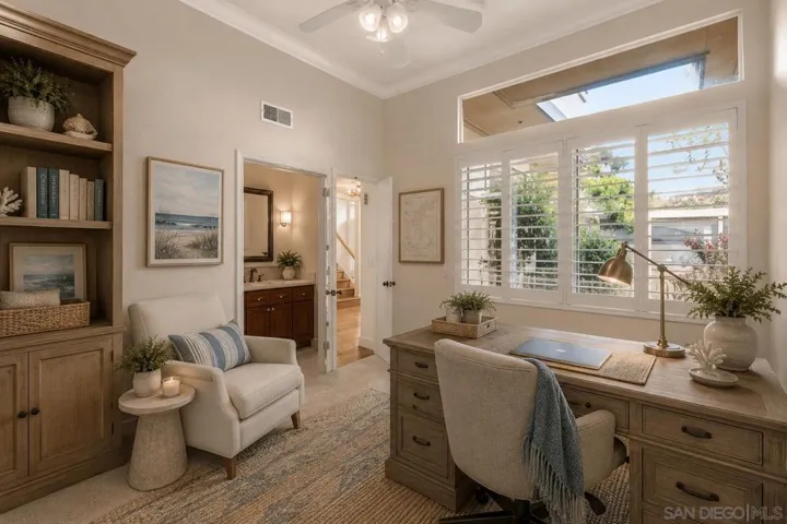 1st Floor Guest Bedroom Virtually Staged as an Optional Office/Den and Custom Curated Plantation Shutters. Virtually Staged.