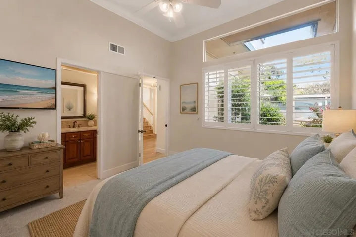 1st Floor Guest Bedroom with High Ceilings, Bathroom Ensuite and Custom Curated Plantation Shutters. Virtually Staged.