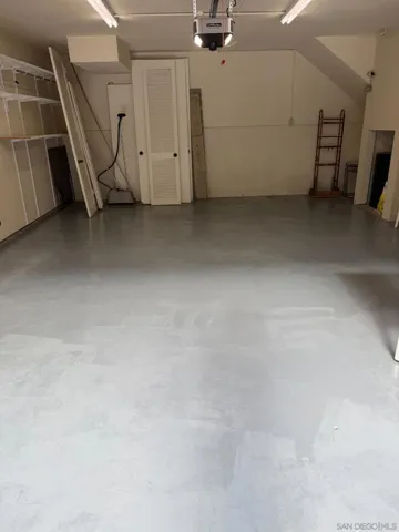 Large Two Car Garage with a Sink and Shelves.