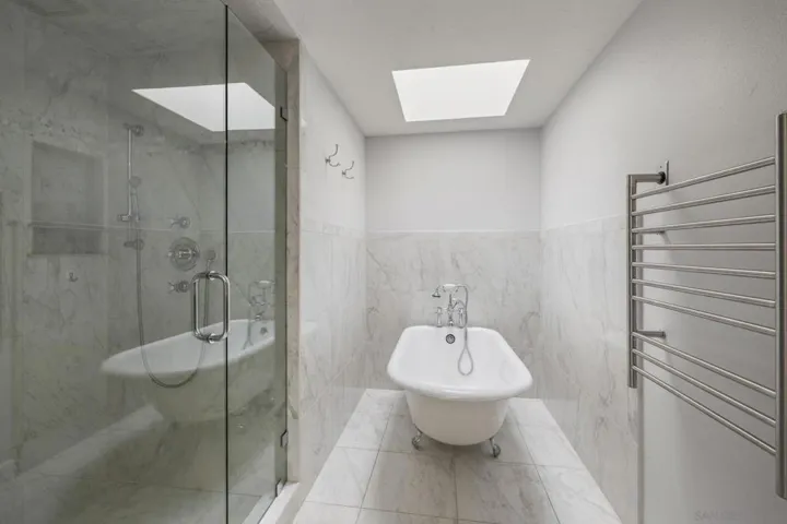 Fully Updated Luxury Spa Primary Bathroom with a Separate Closet, Water Closet including a Bidet, Heated Towel Rack, Footed Tub, Spa Shower and two Sky Lights, Offering Great Natural Lighting.