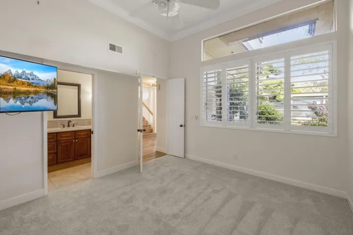 1st Floor Guest Bedroom with High Ceilings, Bathroom Ensuite and Custom Curated Plantation Shutters.
