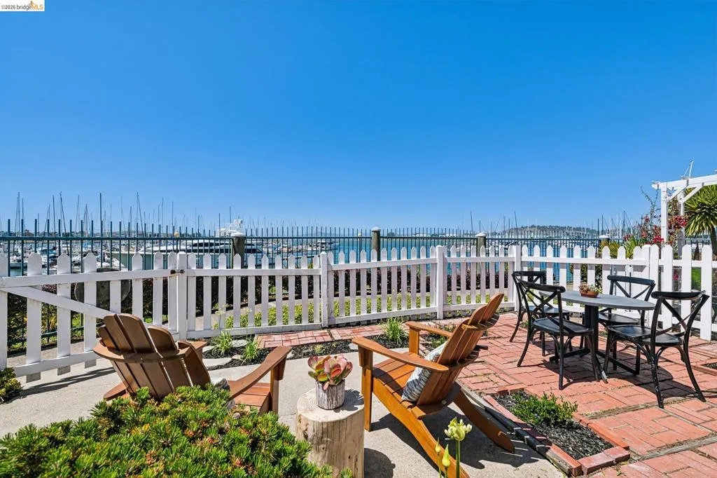 Picket fence patio overlooking a marina with numerous boats