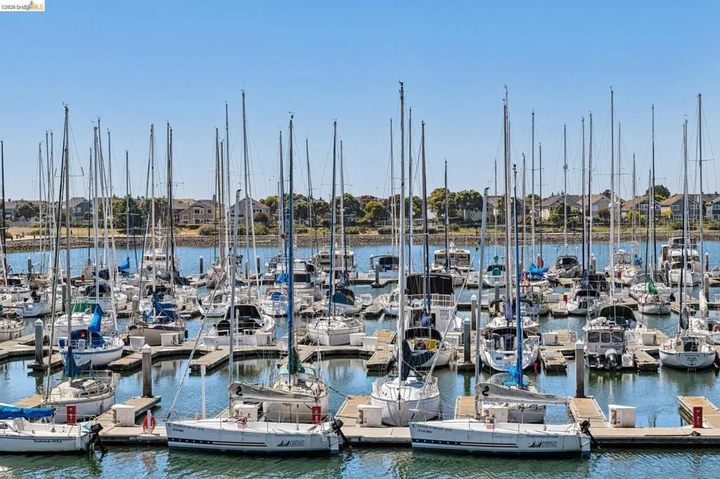 Marina setting featuring multiple boats docked at individual slips