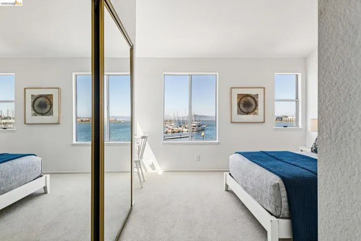 Light-filled room featuring multiple windows with water and marina scenery