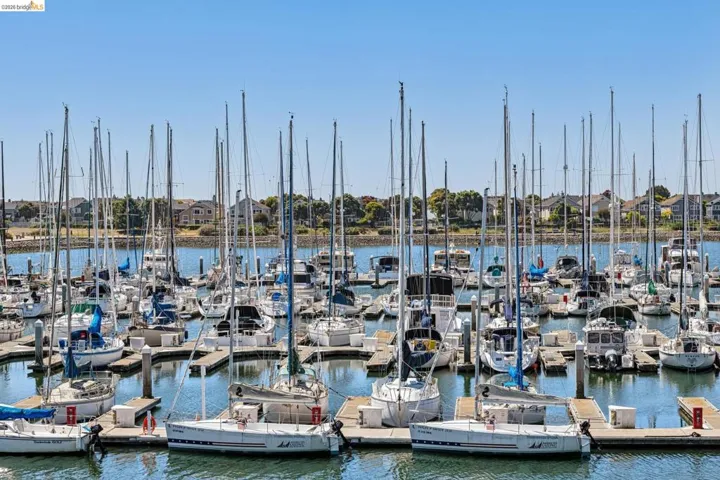 Marina setting featuring multiple boats docked at individual slips